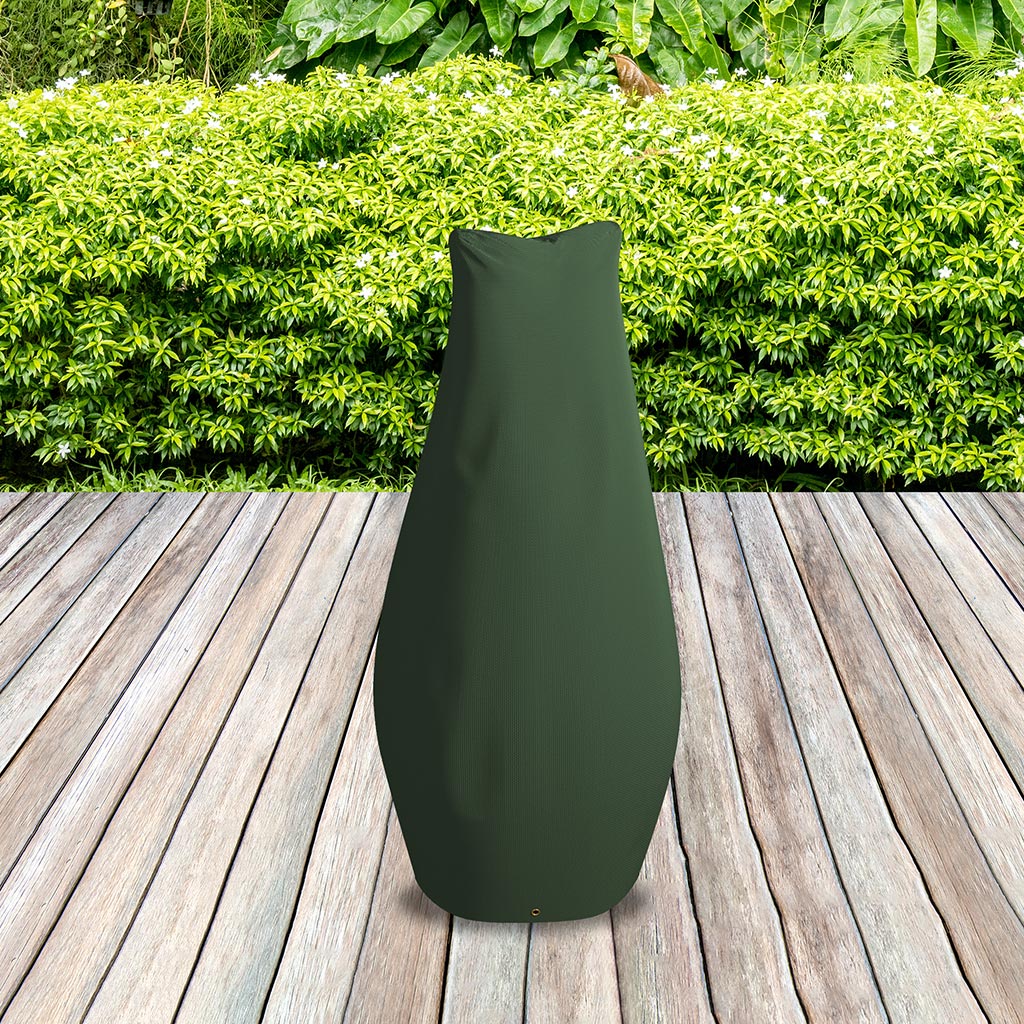 Large Chimenea Cover Green - placed in a garden on grass with plants behind 