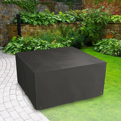 Bosmere All-Weather (Modular) 4 Seater Cube Set Cover Extra - Black placed in a garden on grass with plants behind 