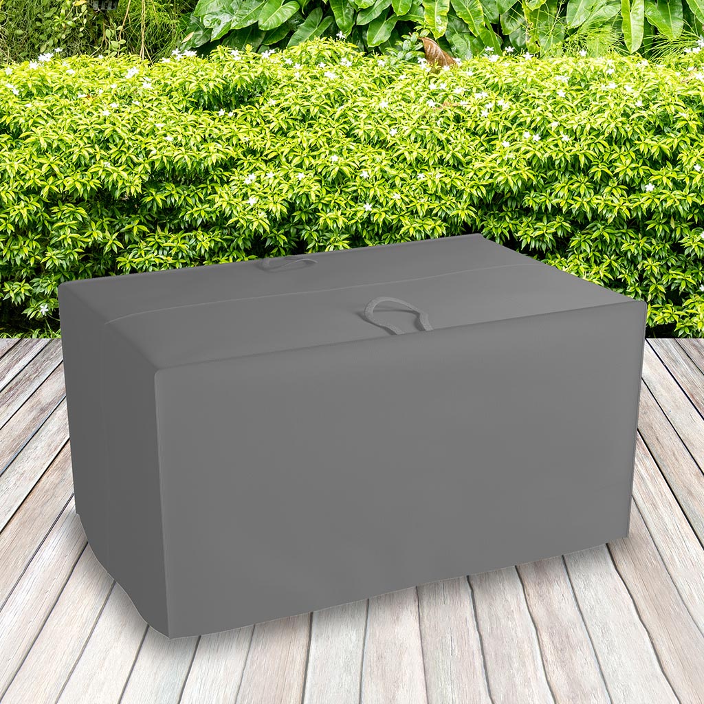 All-weather Cushion Storage Bag, Charcoal - placed in a garden on grass with plants behind 