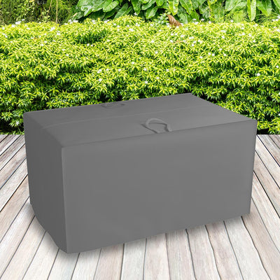 All-weather Cushion Storage Bag, Charcoal - placed in a garden on grass with plants behind 