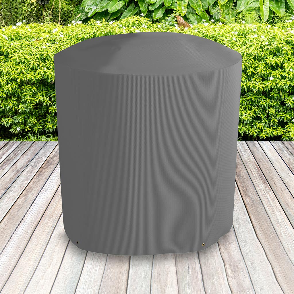 All-weather Kettle BBQ Cover placed in a garden on grass with plants behind 