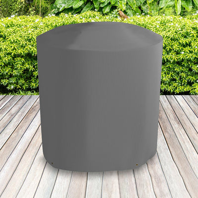All-weather Kettle BBQ Cover placed in a garden on grass with plants behind 