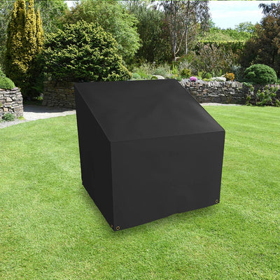 All-weather - Armchair Cover - Large, Charcoal, placed in a garden on grass with plants behind 
