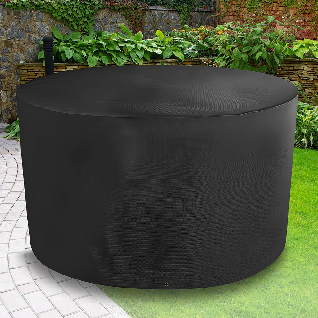 Bosmere All-Weather Circular Table Cover - 4/6 Seat Black placed in a garden on grass with plants behind 