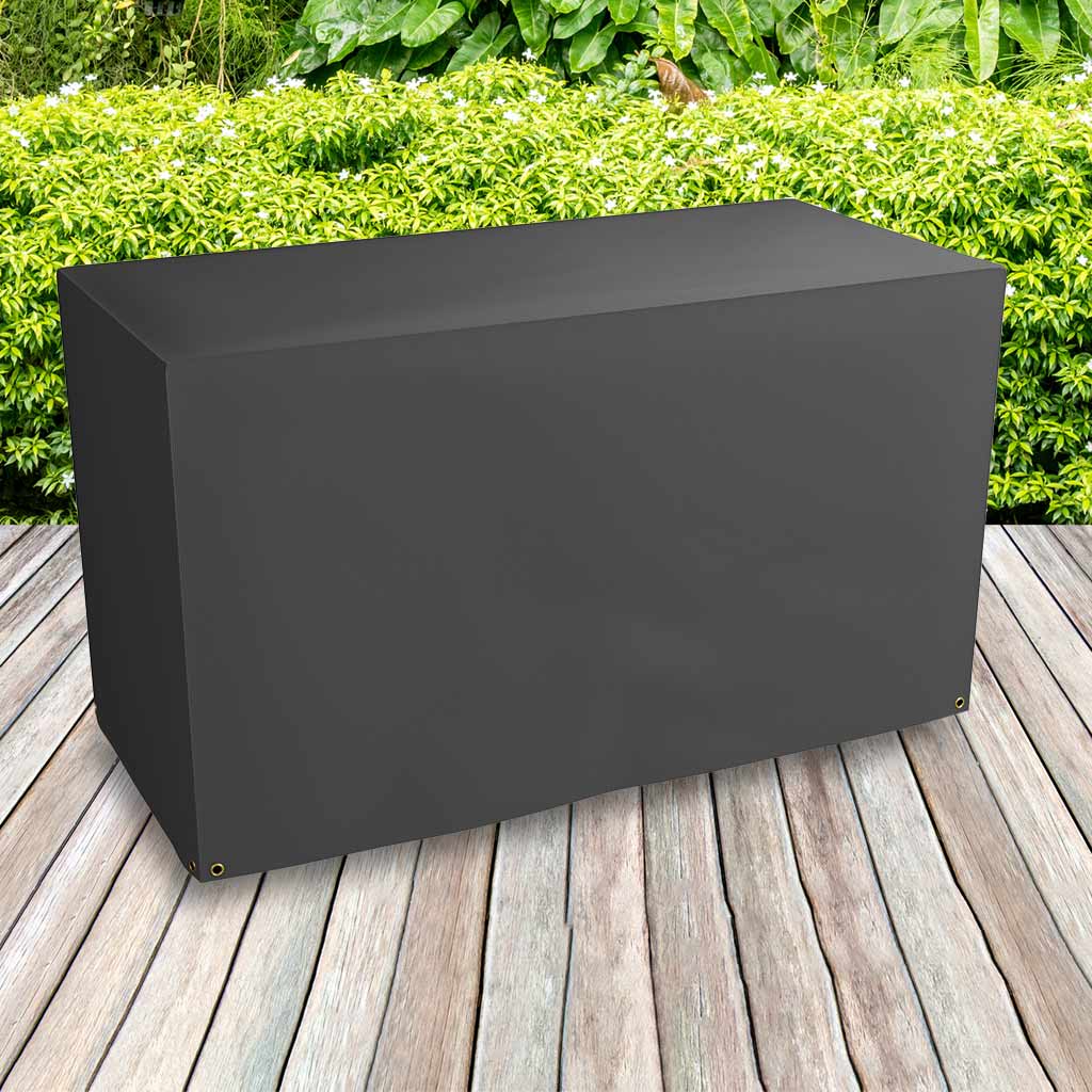 Protector 6000 Trolley Barbecue Cover - Storm Black- placed on decking bushes behind