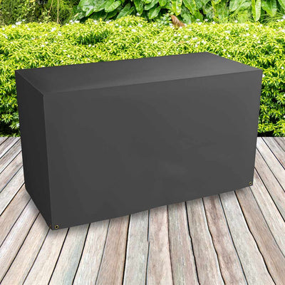 Protector 6000 Trolley Barbecue Cover - Storm Black- placed on decking bushes behind