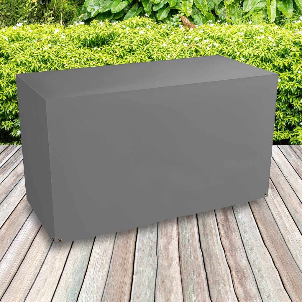 All-weather BBQ Grill Cover - Large , Charcoal - placed in a garden on grass with plants behind 
