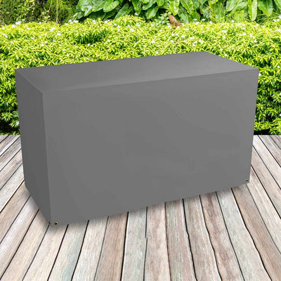 All-weather BBQ Grill Cover - Large , Charcoal - placed in a garden on grass with plants behind 
